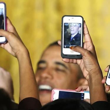 Audeince members hold up Apple iPhones to photograph President Barack Obama after he spoke at a Women's History Month reception.