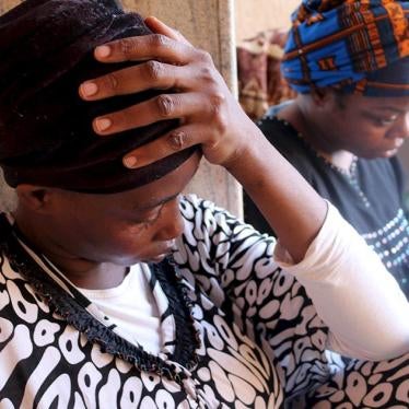 Migrants sit at a detention center in Tripoli after they were detained by the Libyan authorities on September 17, 2015.