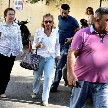 Turkish journalist Nazli Ilicak, a well-known commentator and former parliamentarian, is escorted by a police officer and her relatives after being detained in Bodrum, Turkey on July 26, 2016.