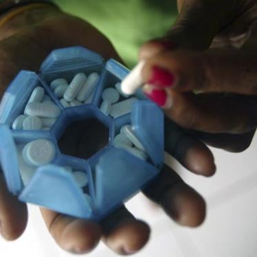 A woman who is infected with HIV prepares her medicines in a shelter house in Jayapura of the Indonesia Papua province November 27, 2008. 