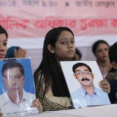 Relatives hold portraits of disappeared family members at an event calling for the end of enforced disappearances, killings, and abductions, in Dhaka, Bangladesh, August 30, 2014. 