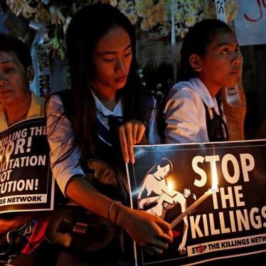 Protesters and residents hold lighted candles and placards at the wake of Kian Loyd delos Santos, a 17-year-old high school student, who was among the people shot dead last week in an escalation of President Rodrigo Duterte's war on drugs in Caloocan city