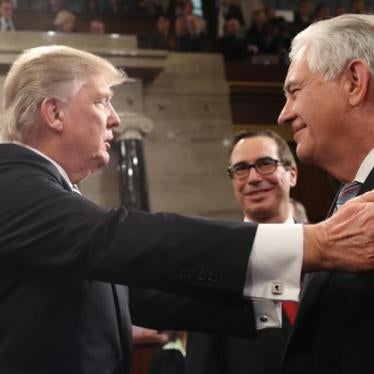 President Donald Trump greets Secretary of the Treasury Steve Mnuchin (C) and Secretary of State Rex Tillerson (R) after delivering his first address to a joint session of Congress, February 28, 2017. 