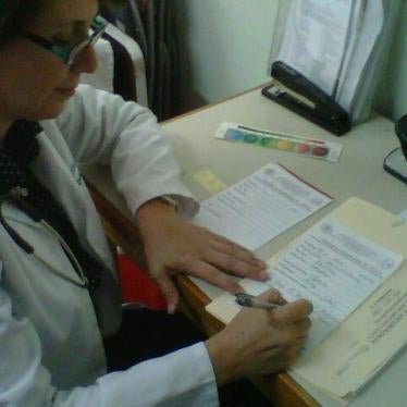 Dr. Eva Duarte writing prescriptions for her patients