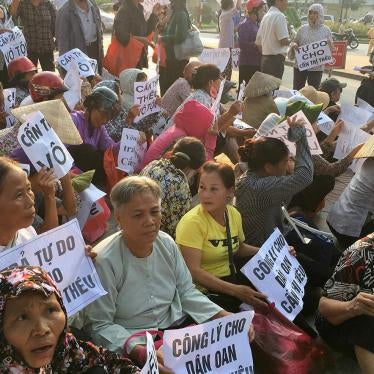 Farmers from Duong Noi village protest during the trial of Can Thi Theu, a farmer and land rights activist in Hanoi. The placards read "Can Thi Theu is innocent," "Justice for innocent Can Thi Theu" and "Make arrest - grabbing land is criminal," September