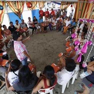 Women survivors of super typhoon Haiyan listen during a lecture on prevention of gender-based violence by a United Nations Population Fund (UNFPA) volunteer in Tacloban city in the central Philippines on December 14, 2013. 