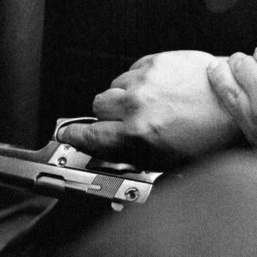 Hands of the bodyguard of Medellín’s human rights ombudsman, Jorge Ceballos. Ceballos was the target of numerous death threats by right-wing armed groups due to his work as a human rights defender.