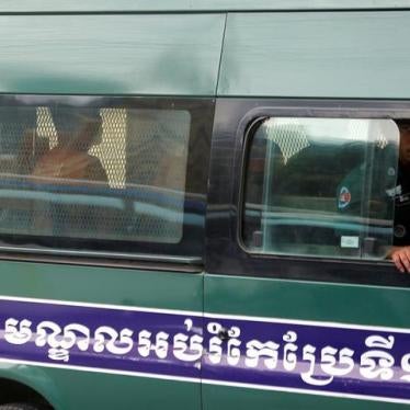 Uon Chhin and Yeang Sothearin, former journalists of the Radio Free Asia (RFA), sit inside a police vehicle as they arrive for a bail hearing at the Appeal Court in Phnom Penh, Cambodia, April 19, 2018. REUTERS/Samrang Pring