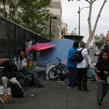 People walk around the neighboring streets around the Fred Jordan Mission, in Los Angeles, California, U.S. May 12, 2018.
