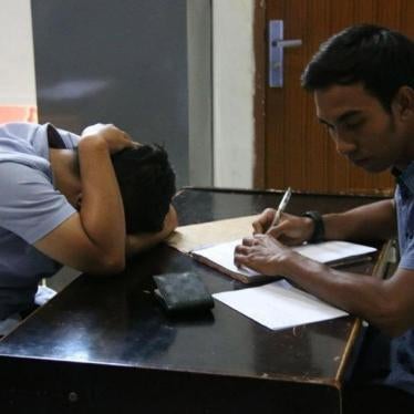 On March 29, 2018, vigilantes forcibly entered a private house in Aceh province and called the Sharia (Islamic law) police, who arrested two male college students for allegedly having sex. A police officer questions one of the men in the Sharia