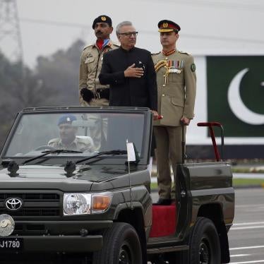 Pakistani President Arif Alvi, center on a military vehicle, reviews a military parade to mark Pakistan National Day, in Islamabad, Pakistan, Saturday, March 23, 2019.