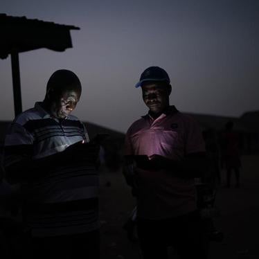 Two men check their phones in Kaduna, Nigeria