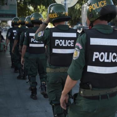 Riot police walk toward their positions to block supporters of the opposition Cambodia National Rescue Party marching toward an appeals court in Phnom Penh, Cambodia, Tuesday, Sept. 26, 2017. 
