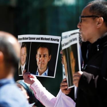 People hold signs calling for China to release Canadian detainees Michael Spavor and Michael Kovrig during a court appearance by Huawei's Financial Chief Meng Wanzhou, outside of British Columbia Supreme Court building in Vancouver, British Columbia