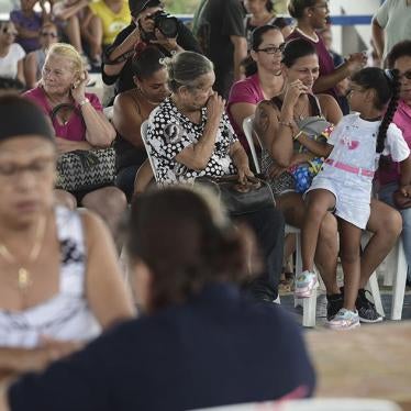 People wait at the Jose de Diego Elementary School to file FEMA forms for federal aid in the aftermath of Hurricane Maria in Las Piedras, Puerto Rico