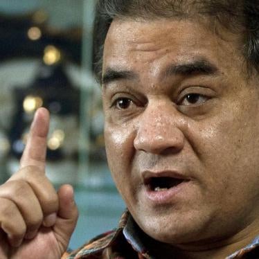 In this Feb. 4, 2013 file photo, Ilham Tohti, an outspoken scholar of China's Uighur minority, gestures as he speaks during an interview at his home in Beijing, China. 