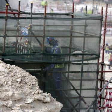 A foreign worker climbs scaffolding at the Al-Wakra Stadium that is under construction for the 2022 World Cup, in Doha, Qatar. 