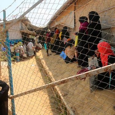 Rohingya refugees wait at a crowded relief distribution point at the Kutupalong refugee camp in Ukhia, Cox's Bazar, Bangladesh, March 24, 2020.