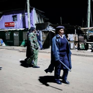 Kenyan police carrying batons and teargas patrol looking for people out after curfew in the Kibera slum, or informal settlement, of Nairobi, Kenya, March 29, 2020.