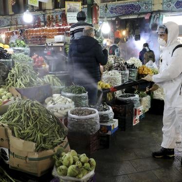 A firefighter disinfects a traditional shopping center to help prevent the spread of the new coronavirus in northern Tehran, Iran.