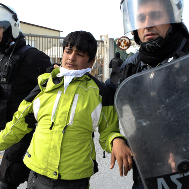 Refugee being taken away by Greek police