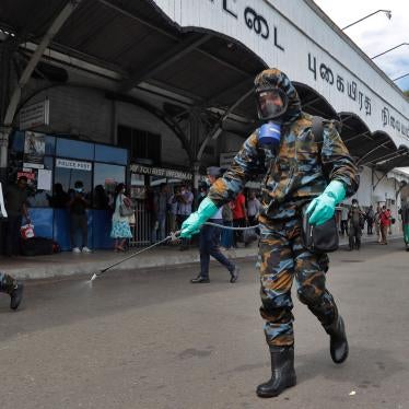 Sri Lankan government soldiers in protective clothes spray disinfectants at a railway station in Colombo, Sri Lanka, Wednesday, March 18, 2020.