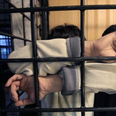 A detained migrant from a former Soviet republic waits in a holding cell at a police station in Russia's Siberian city of Krasnoyarsk. 