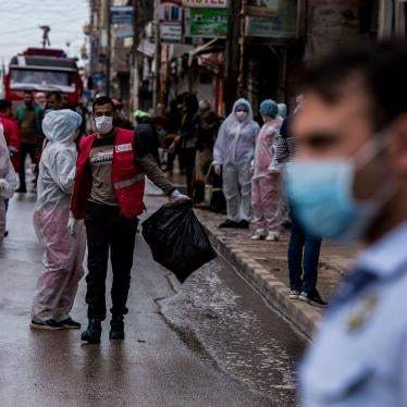 Medical workers oversee the disinfection of streets to prevent the spread of coronavirus in Qamishli, Syria, March 24, 2020.