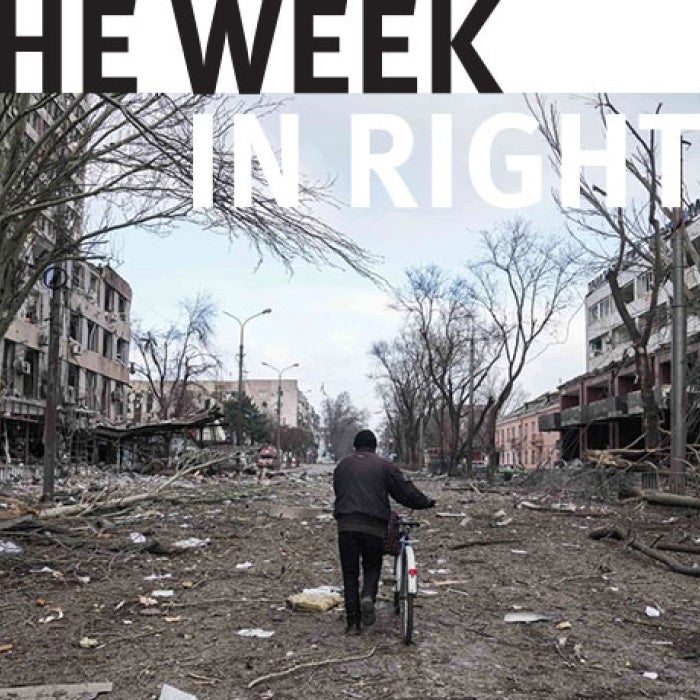 Person walking alongside bicycle. 