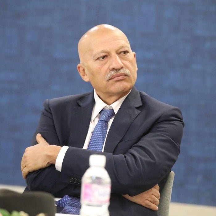 Photo of a man with his arms crossed