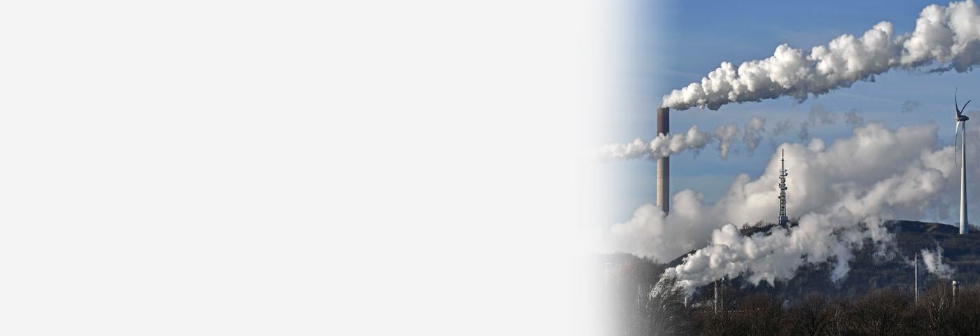 A Uniper coal-fired power plant and a BP refinery steam beside a wind generator in Gelsenkirchen, Germany on Jan. 16, 2020. 